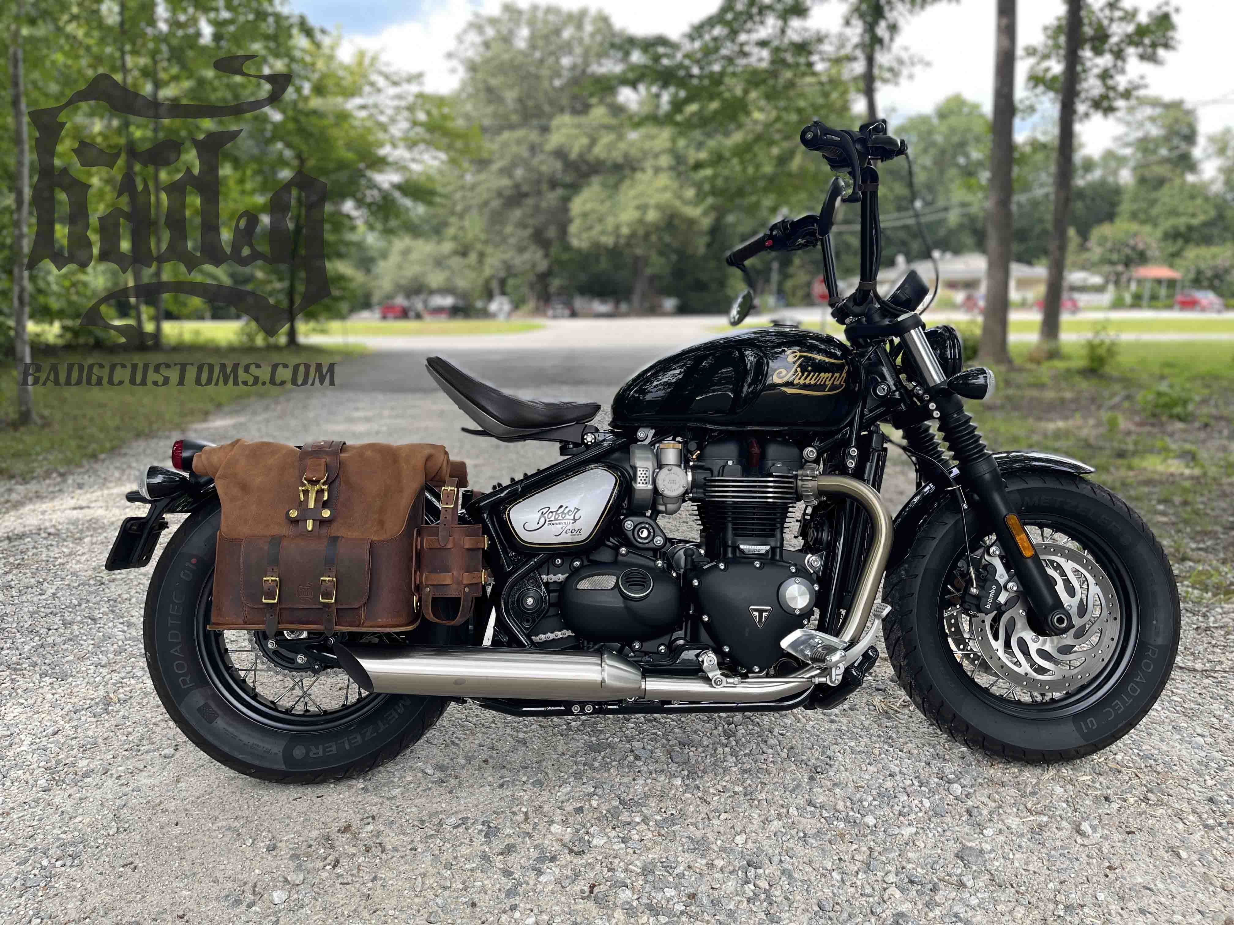 Triumph Bonneville Bobber Panniers Rolltop Swingarm Saddlebags. Hand crafted in USA with premium veg tan water buffalo leather, waterproof liners and solid brass hardware. BAD&G Customs TBP01